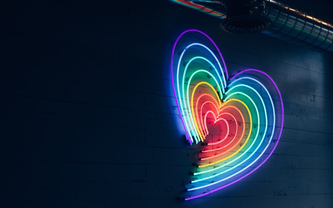 a rainbow neon heart sign