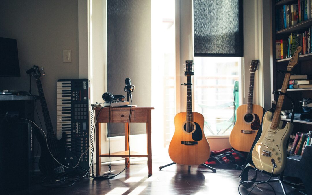 an indoor music studio with three guitars