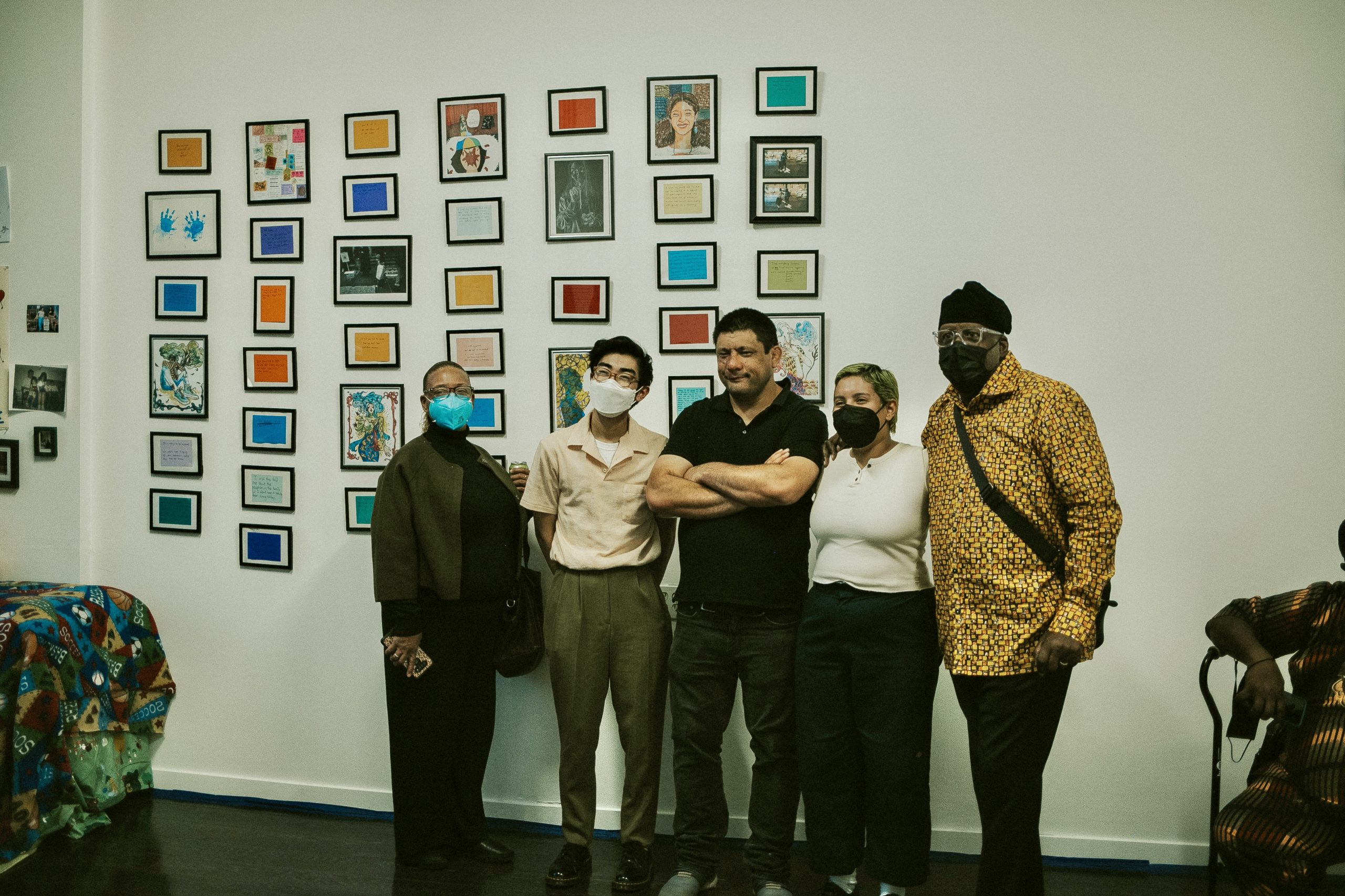 Rite of Passage Exhibition artists posing against an art gallery wall