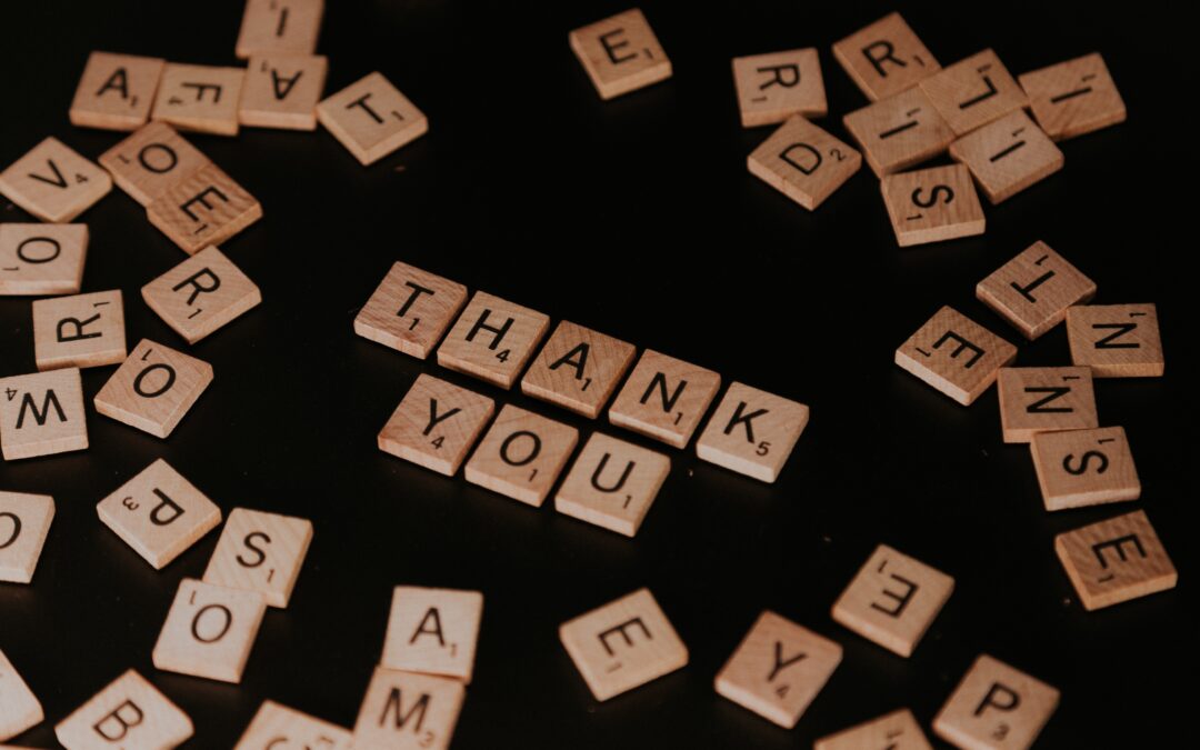 Image of a board with a game of scrabble with the words thank you in the center