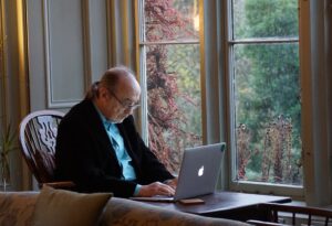 an older man struggling to access digital mental health resources on a laptop
