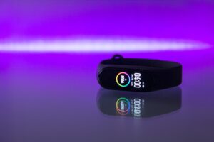 Digital watch with neon purple background
