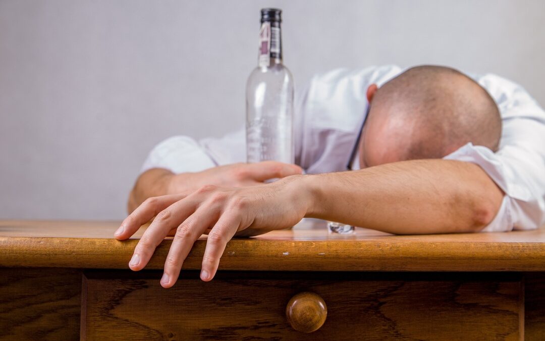 image of a Man with an empty bottle of Alcohol, Hangover