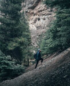 man walking up mountain