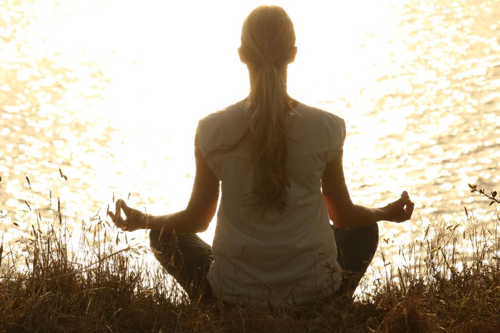 view of a woman in a sitting meditation