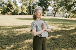 Elderly woman meditating